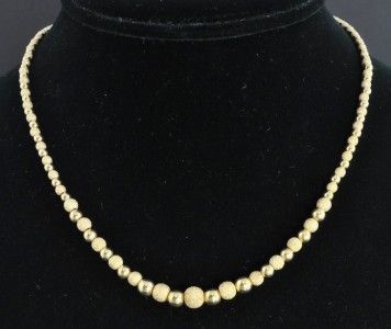   is a stylish Italian bead necklace crafted from solid 14K yellow gold