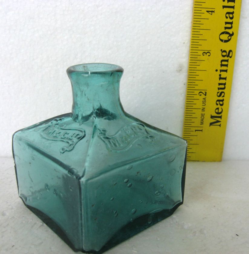 Antique ink bottle blue green embossed banner M.&C. LTD. nice crude 